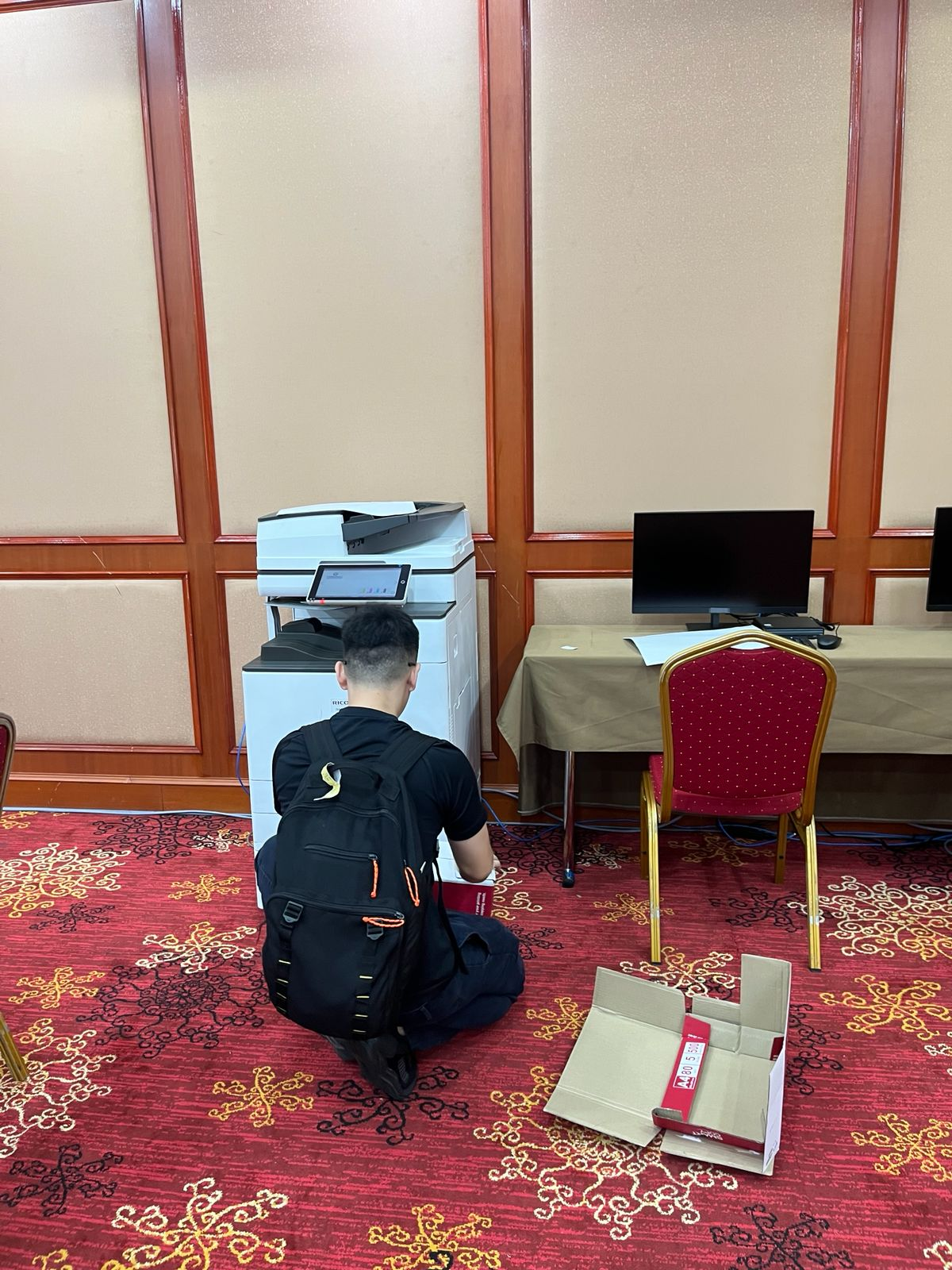 BSS technician setting up printer at event